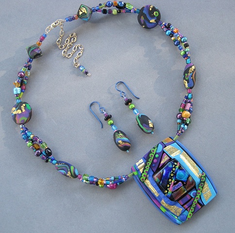 beaded polymer clay pendant featuring fused glass focal