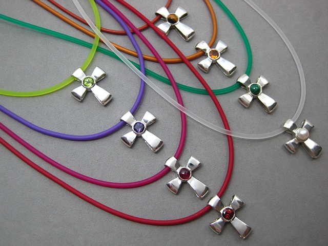 gemstone ribbon crosses shown on colored cord necklaces