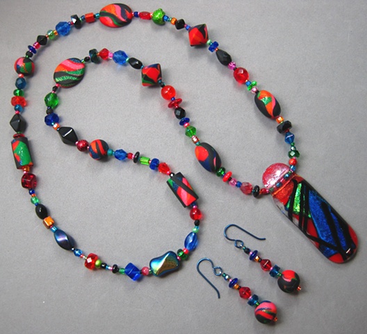 fused glass pendant strung into a beaded necklace set by Nancy Denmark