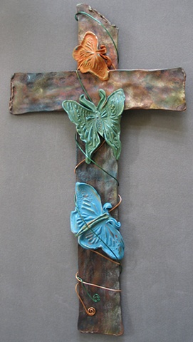 copper wall cross with polymer clay butterfly embellishment