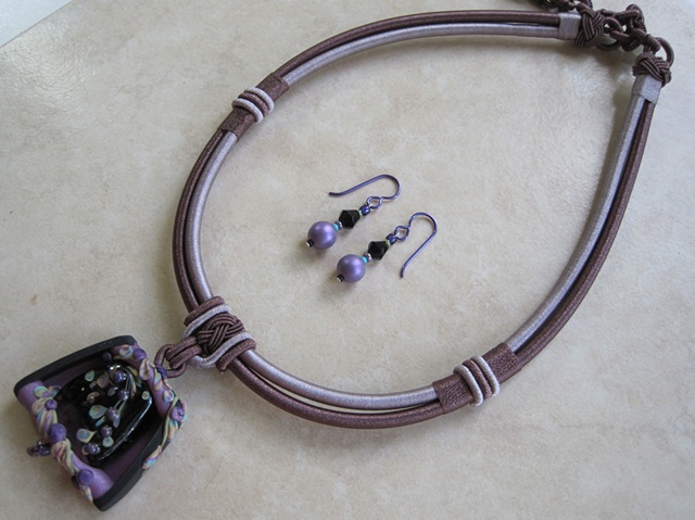 polymer clay pendant featuring glass lampwork bead on cord
