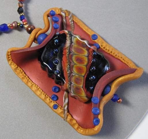 polymer clay pendant features lampwork bead