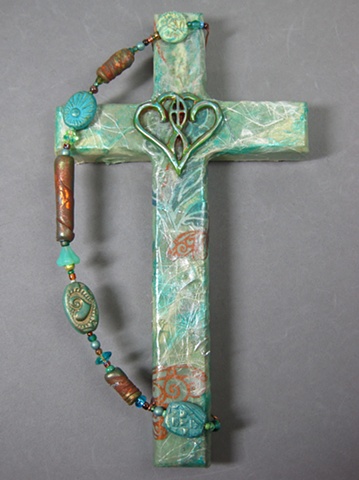 One In The Spirit_ embossed metal symbol design_ on collage wall cross