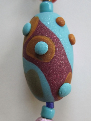 close up view of my handmade polymer clay bead