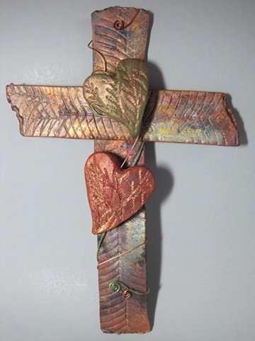 textured copper wall cross with 2 polymer clay hearts by Nancy Denmark
