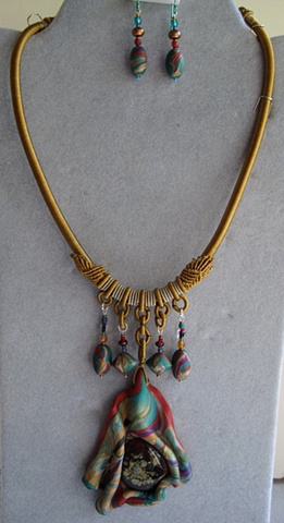 polymer clay pendant featuring glass cab