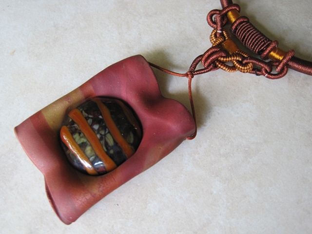 polymer pendant on cord featuring lampwork glass cab