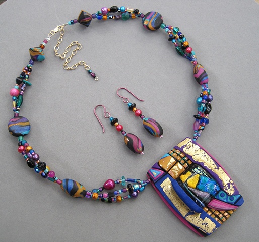 beaded necklace featuring polymer clay pendant with fused glass focal