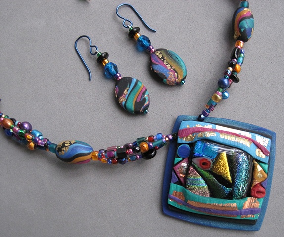 beaded necklace featuring polymer clay pendant with fused glass focal