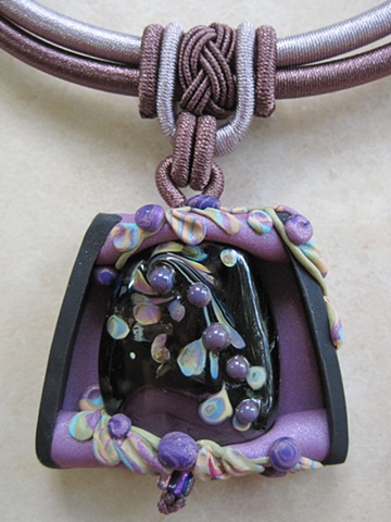 polymer clay pendant with lampwork bead focal
