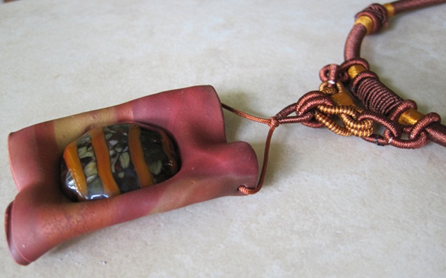 polymer clay pendant featuring lampwork cab