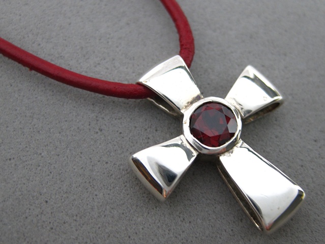 Sterling silver ribbon cross with faceted garnet Nancy Denmark