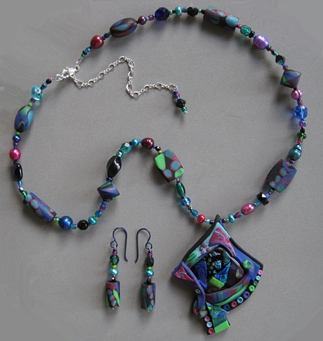 polymer clay pendant necklace featuring a fused glass focal