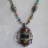 WIRE WRAP CAGE PENDANT
FEATURING LAMPWORK BEAD ON
POLYMER CLAY BEADED NECKLACE SET