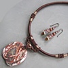 POLYMER PENDANT WITH ROSETTA STONE ON CORD
