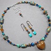 TURQUOISE & GOLD 
SHORT BEAD STRAND WITH
PUFFED HEART GLASS PENDANT
