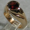 14K UP SWIRL RING W/ GARNET