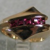 14K RING W/ CHANNEL OF RUBIES
