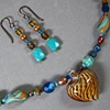 TURQUOISE & GOLD 
SHORT BEAD STRAND WITH
PUFFED HEART GLASS PENDANT
CLOSE UP VIEW