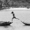 boy jumping canoes