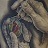 Hands Painting Egg Tattoo on ribs