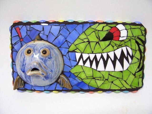 stained glass mosaic of a shark and small fish