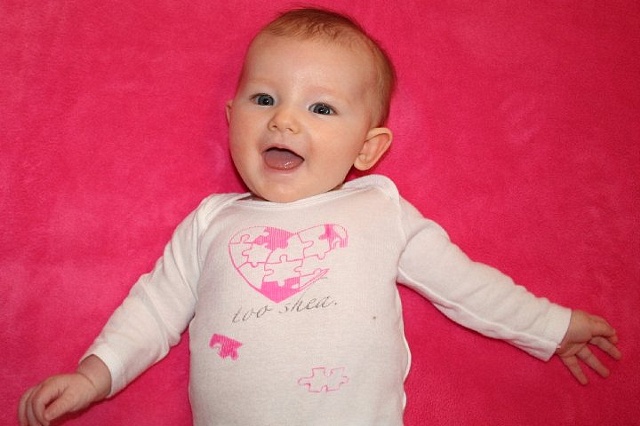 Charlotte in "too shea" baby wear!