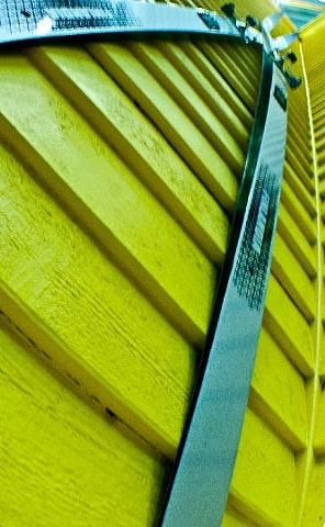 Skis on Yellow Wall