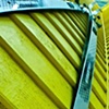Skis on Yellow Wall