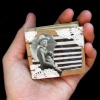 tiny little man with a tiny little umbrella on an itty bitty book
