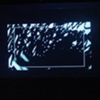 "Chance Operations" exhibition: Lynn Marie Kirby's "Meltdown" video projected onto wall of neighboring building