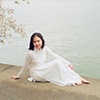 Young woman posing with cherry blossoms