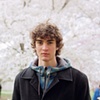 Young man with cherry blossoms