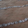 Exhibition Flying Carpet Prayers at El P&oacute;sito
On the floor, rolled newspaper from Catalunya in the shape of Ca&ntilde;adas Real