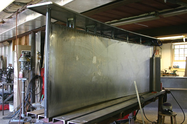 attaching a sheet metal skin over the structure on the Goldenbelt entry way desk commission