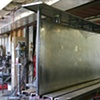 attaching a sheet metal skin over the structure on the Goldenbelt entry way desk commission
