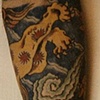 Left arm tattoo of Japanese Lion & Cloud