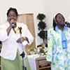 Pastor Yul Dorn's sister and daughter singing during the service at True Light Church of God in Christ in Daly City.