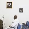 Photographs of Pastor Yul Dorn, Jr.'s parents on the wall at his parish True Light Church of God in Christ in Daly City.