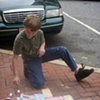 Visitors to The Box, playing with sidewalk chalk and telling ghost stories.