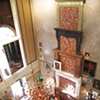 Radiating Disk Chandelier and Log Filled Fireplaces