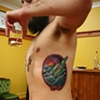 chris's message in a bottle ribs tattoo