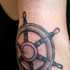 ash's ships wheel tattoo