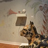 a past presents a future, laying ocelot with broken mountain, rocket artifact and wall drawing